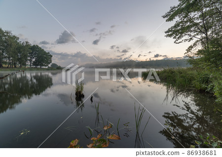foggy flatland riverside at summer sunrise time foggy flatland riverside at summer sunrise time 86938681