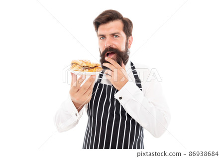 Serious man baker serving delicious croissant isolated on white, dessert Serious man baker serving delicious croissant isolated on white, dessert 86938684