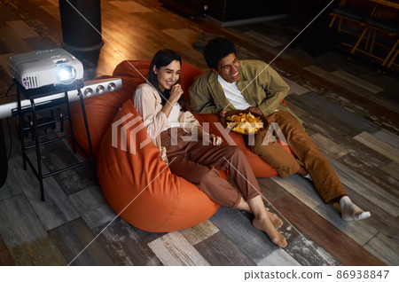 Family couple watching television projector at home 86938847