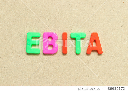 Color alphabet letter with word EBITA (abbreviation of  earnings before interest, taxes and amortization) on wood background 86939172