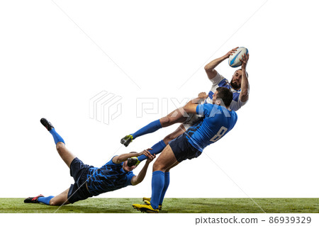 Sportive men, professional rugby players playing rugby football on grass field isolated on white background. Sport, activity, health, hobby, occupations concept Sportive men, professional rugby players playing rugby football on grass field isolated on white background. Sport, activity, health, hobby, occupations concept 86939329