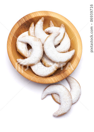 Traditional German or Austrian Vanillekipferl vanilla kipferl cookies on a plate isolated on white background Traditional German or Austrian Vanillekipferl vanilla kipferl cookies on a plate isolated on white background 86939716