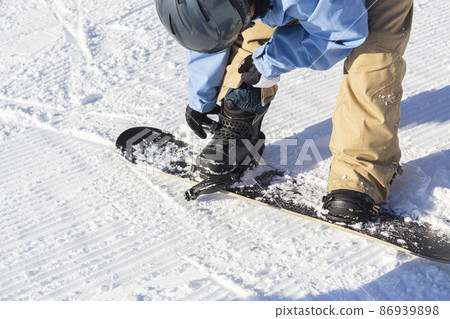 Children's hands with snowboard bindings Children's hands with snowboard bindings 86939898