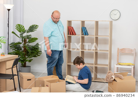 While arranging the books on the bookcase, my son started reading one. While arranging the books on the bookcase, my son started reading one. 86940234