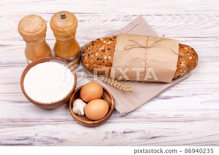 Fresh dough over white table with flour. Home bread baking background. Fresh dough over white table with flour. Home bread baking background. 86940235