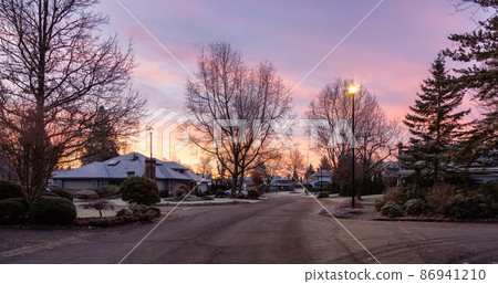 View of Residential Suburban Neighborhood Street in a modern city View of Residential Suburban Neighborhood Street in a modern city 86941210