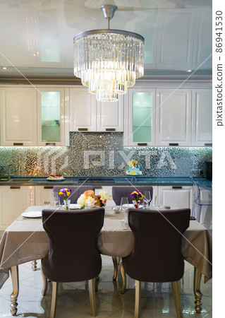 kitchen. served dining table with utensils and flowers in the dining room.  86941530