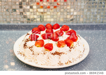 cake decorated with whipped cream and fresh strawberries. homemade dessert. cake decorated with whipped cream and fresh strawberries. homemade dessert. 86941548