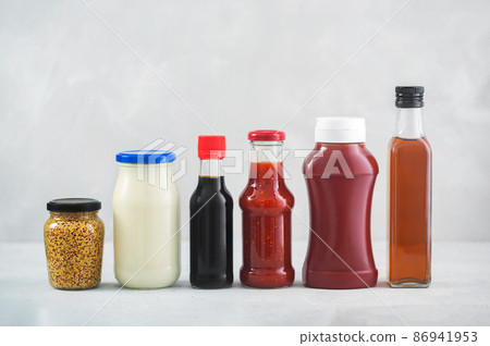 A set of different sauces on the table, gray background 86941953