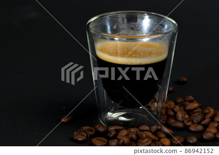 Den Helder, the Netherlands. January 2022. Close up of coffee with cognac on black background. 86942152