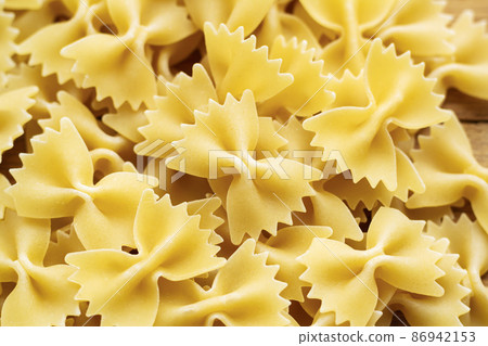 Heap of raw farfalle italian pasta background 86942153