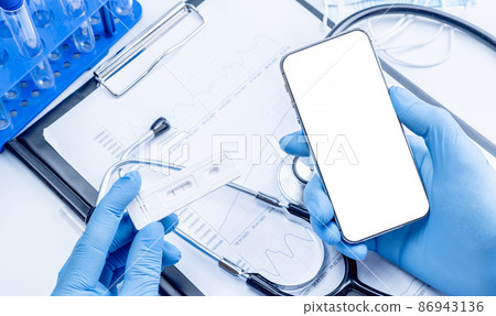 Cellphone mockup. Syringe with needle, hospital healthcare charts, doctor stethoscope and black smartphone with blank screen for medical equipment background with clipping path, copy space. 86943136