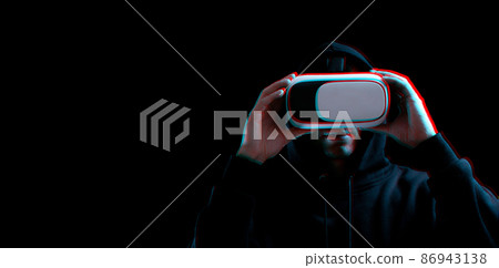 Vr goggles virtual reality blured. Young man in digital helmet for 3d virtual reality game on dark background. Study and virtual world in 3D simulation with glitch effect. 86943138