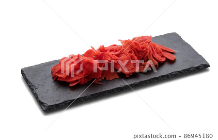 pickled pink ginger on a black stone board, spice for sushi. White background pickled pink ginger on a black stone board, spice for sushi. White background 86945180