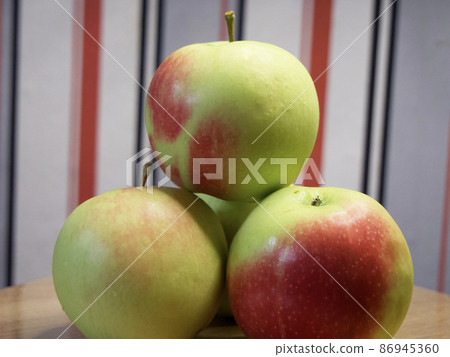 A bunch of juicy red-sided apples, a close-up shot. Ripe fruit. A bunch of juicy red-sided apples, a close-up shot. Ripe fruit. 86945360