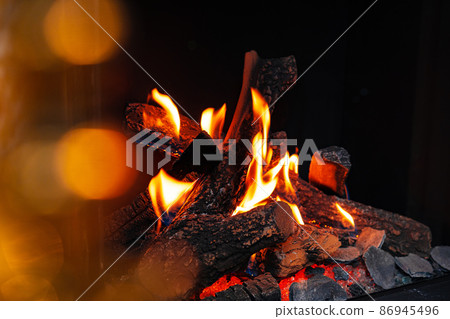 Wood logs burning in fireplace close up Wood logs burning in fireplace close up 86945496
