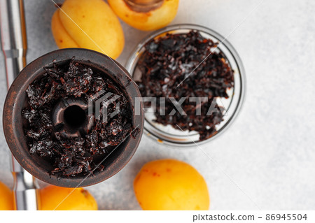Hookah parts with fresh apricots on table Hookah parts with fresh apricots on table 86945504