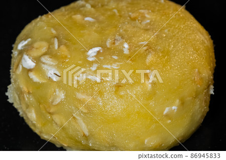 One uncooked oatmeal cookie on metal sheet in oven: close up One uncooked oatmeal cookie on metal sheet in oven: close up 86945833
