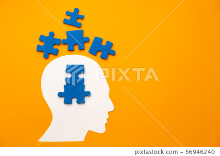 Papercut head silhouette with puzzle pieces on yellow background 86946240