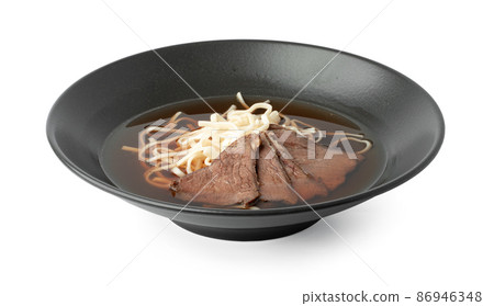 Asian soup with beef and udon noodles isolated on white Asian soup with beef and udon noodles isolated on white 86946348
