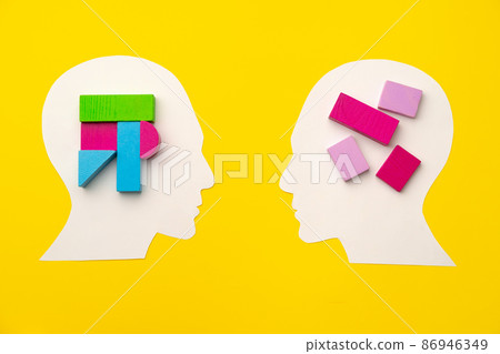 Papercut head silhouette with toy constructor pieces on yellow background 86946349