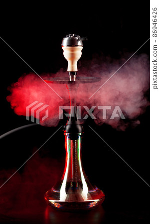 Smoking hookah on black background with color fog Smoking hookah on black background with color fog 86946426
