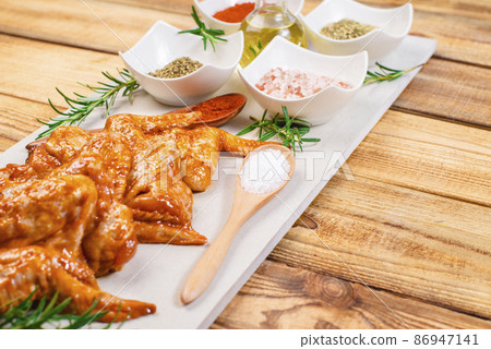 Chicken wings are raw in the marinade. Oven baking wings. Semifinished. Fast cooking.Raw Marinated chicken meat wings for BBQ, Chicken wings are raw in the marinade. Oven baking wings. Semifinished. Fast cooking.Raw Marinated chicken meat wings for BBQ, 86947141