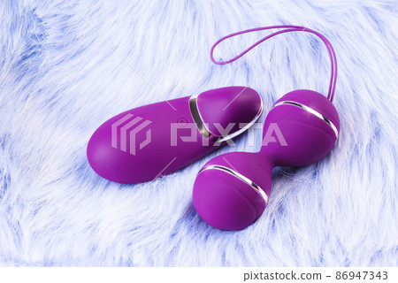 Pink vaginal balls,pink background.Double vaginal balls. Strengthening the intimate muscles of the vagina.dildo vibrator. Strengthening the intimate muscles of the vagina. 86947343