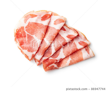 Italian dried ham. Coppa Stagionata isolated on white background. Italian dried ham. Coppa Stagionata isolated on white background. 86947744