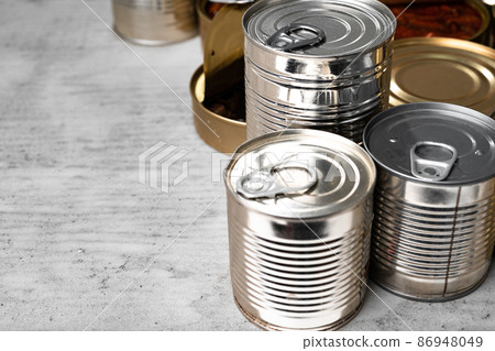 Tin cans with conserved food on gray surface Tin cans with conserved food on gray surface 86948049