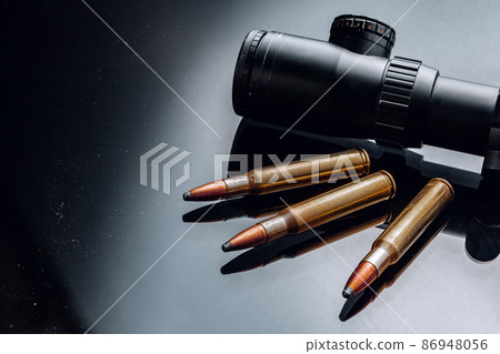 Optical scope for rifle on black background Optical scope for rifle on black background 86948056
