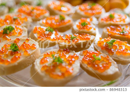 Plate with sandwiches with red caviar Plate with sandwiches with red caviar 86948313
