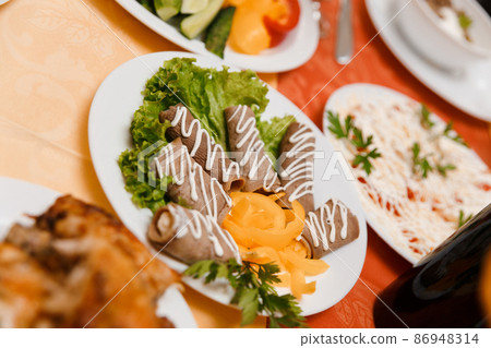 Dish with sliced meat rolls Dish with sliced meat rolls 86948314