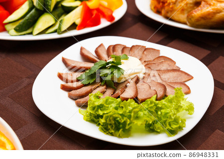 Dish with sliced meat products 86948331