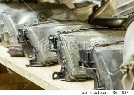 Used headlamp components for sale on the store shelf. Used headlamp components for sale on the store shelf. 86948371