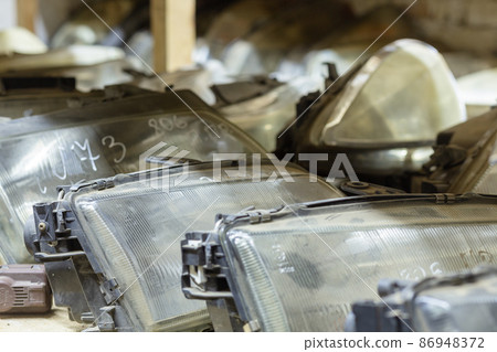 Used headlamp components for sale on the store shelf. 86948372