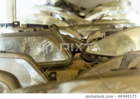 Used headlamp components for sale on the store shelf. Used headlamp components for sale on the store shelf. 86948373