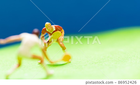 Two dolls playing tennis under the blue sky Two dolls playing tennis under the blue sky 86952426