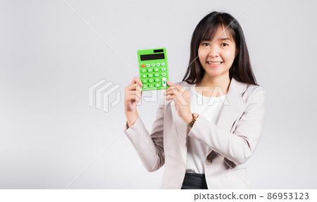 Woman confident smiling holding electronic calculator Woman confident smiling holding electronic calculator 86953123