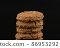 Delicious tasty snack of brown cookies with chocolate chip and peanut isolated on black background 86953292