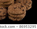 Delicious tasty snack of brown cookies with chocolate chip and peanut isolated on black background 86953295