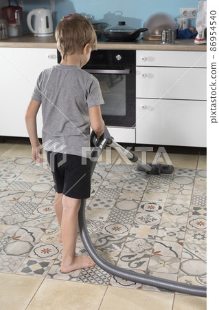 pre-school boy helps his mother, does homework, vacuums floor 86954540