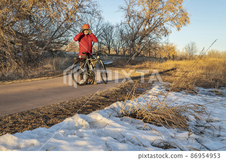 senior male cyclist with his touring bike on a biking trail 86954953
