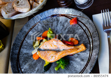 Salmon fish with vegetables served at plate with balsamic 86955474
