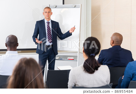 Businessman presenting business project to his team members Businessman presenting business project to his team members 86955484