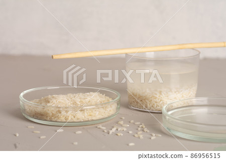 Jar of rice water for skin care face cleansing cosmetic product. Holistic beauty concept, fermented beauty care trend Jar of rice water for skin care face cleansing cosmetic product. Holistic beauty concept, fermented beauty care trend 86956515