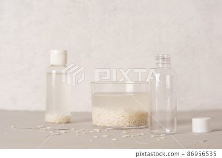 Jar of rice water for skin care face cleansing cosmetic product. Holistic beauty concept, fermented beauty care trend. Copy space Jar of rice water for skin care face cleansing cosmetic product. Holistic beauty concept, fermented beauty care trend. Copy space 86956535