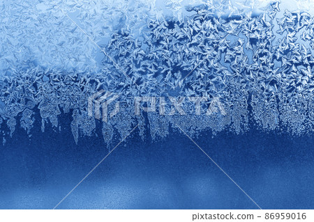 Beautiful ice pattern on window glass, winter texture Beautiful ice pattern on window glass, winter texture 86959016