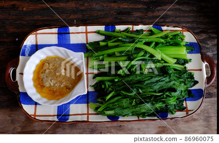 boiled choy sum with tofu cheese on plate 86960075