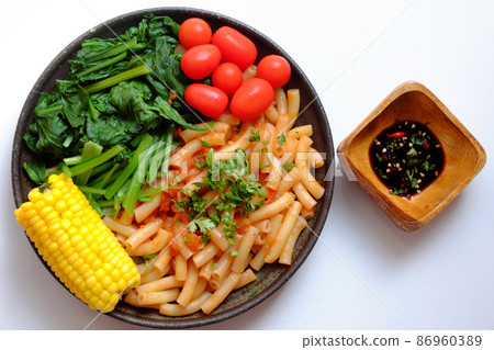 Top view simple vegan food, pasta fried with leaf mustard and tomato sauce Top view simple vegan food, pasta fried with leaf mustard and tomato sauce 86960389